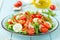 Healthy vegetarian vegetable salad of fresh lettuce, cucumber, sweet pepper and tomatoes. Vegan plant-based food