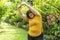 Healthy weight loss concept. Happy overweight young woman stretching before workout in the garden. Fat girl obesity stretch arm