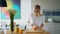 Healthy woman cutting orange on wooden board. Preparing morning breakfast