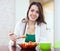 Healthy woman eating veggie salad with spoon