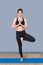 Healthy woman exercising yoga at sport gym