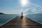 Healthy woman lifestyle exercising vital meditate and practicing yoga at on the bridge seashore, nature background.