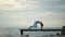 Healthy woman playing yoga pose on beach pier
