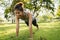 Healthy young Asian runner woman warm up her body by push up before exercise and yoga near lake at park under warm light morning.