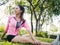 Healthy young asian woman exercising at park. Fit young woman doing training workout in morning.