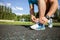 Healthy young athlete is preparing his sneakers