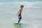 Healthy young boy learning to surf