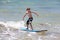 Healthy young boy learning to surf