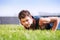 Healthy young man doing pushups outdoors