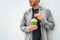 Healthy young man drinking green juice smoothie cup as weight loss detox meal replacement diet. Spinach protein shake