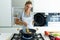 Healthy young woman cooking and mixing food in frying pan in the kitchen at home.