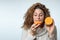 Healthy young woman enjoying a persimmon