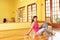 Healthy young woman in gym outfit sitting on the floor