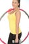 Healthy Young Woman Holding a Dumb Bell and Hula Hoop