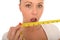 Healthy Young Woman Holding a Tape Measure with Shocked Expression