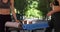 Healthy young women taking seats at table with yoga mats and drinks in Paris