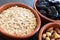 Healty, vegetarian dried fruit breakfast. Set of bowls with dried fruit to enrich a healthy vegan breakfast. Oats, almonds and