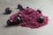 Heap of acai powder and berries on grey table