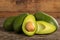 Heap of avocados on wooden table