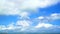Heap beautiful white cloud blue sky huge rolling over the sea and building of the city in rainy season time lapse