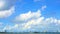 Heap beautiful white cloud blue sky huge rolling over the sea and city in rainy season time lapse