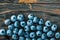 Heap of bilberries on wooden board