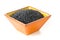 Heap of black organic beluga lentils in orange terracotta bowl o