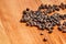 Heap of black peppercorns on cutting board