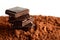Heap of blocks of chocolate on cocoa powder