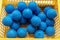 Heap of blue rubber spiky massage balls packing in plastic container
