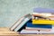 Heap of books with glasses on wooden table