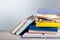 Heap of books with glasses on wooden table