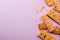 Heap of broken granola bars on violet background