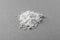 Heap of calcium carbonate powder on grey table