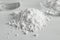 Heap of calcium carbonate powder on white table, closeup