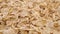 Heap of cereal spelt flakes. Macro