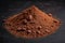 Heap of cocoa powder with cocoa beans