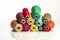 Heap colored industrial spools arranged on white background