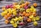 Heap of colored italian pasta on old woden desk. Bunch of raw pasta isolated on gray striped background