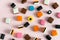 Heap of colorful Liquorice allsorts on pink background. Sweets