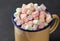 Heap of colorful marshmallows in an enameled mug