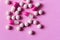 Heap of colorfull pills, tablets, capsules on pink background. Drug prescription for treatment medication health care concept wth