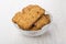 Heap of cookies-muesli in transparent bowl on table