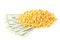 Heap of corn or maize kernels with dollar banknotes over white background - corn cost or prize concept