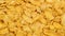 Heap of cornflakes rotating close up, cereal breakfast or food concept, top view flat lay from above