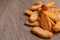 Heap of crispy rusks on wooden table, closeup. Space for text