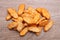 Heap of crispy rusks on wooden table, flat lay