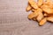 Heap of crispy rusks on wooden table, flat lay. Space for text