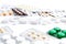 Heap of different pills, in blisters and scattered on white background. Pharmacy and healthcare theme. Medical background