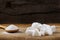 Heap of different sugar cubes shapes and wooden spoon filled wit